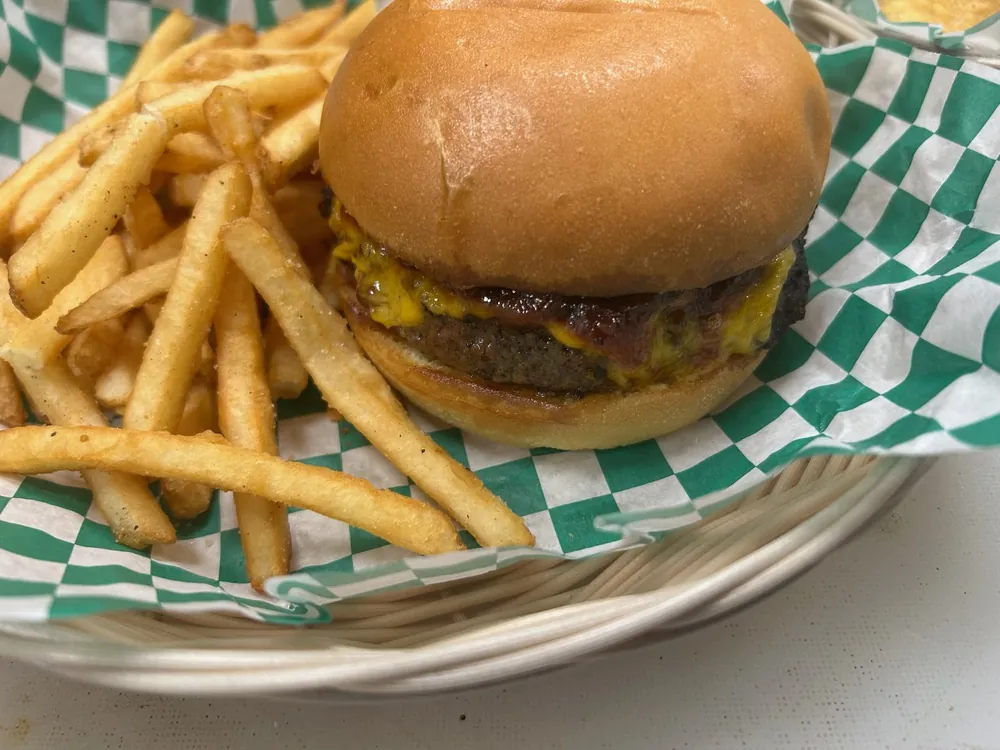 Cheeseburger and fries in a basket at Tee Off at The Wharf